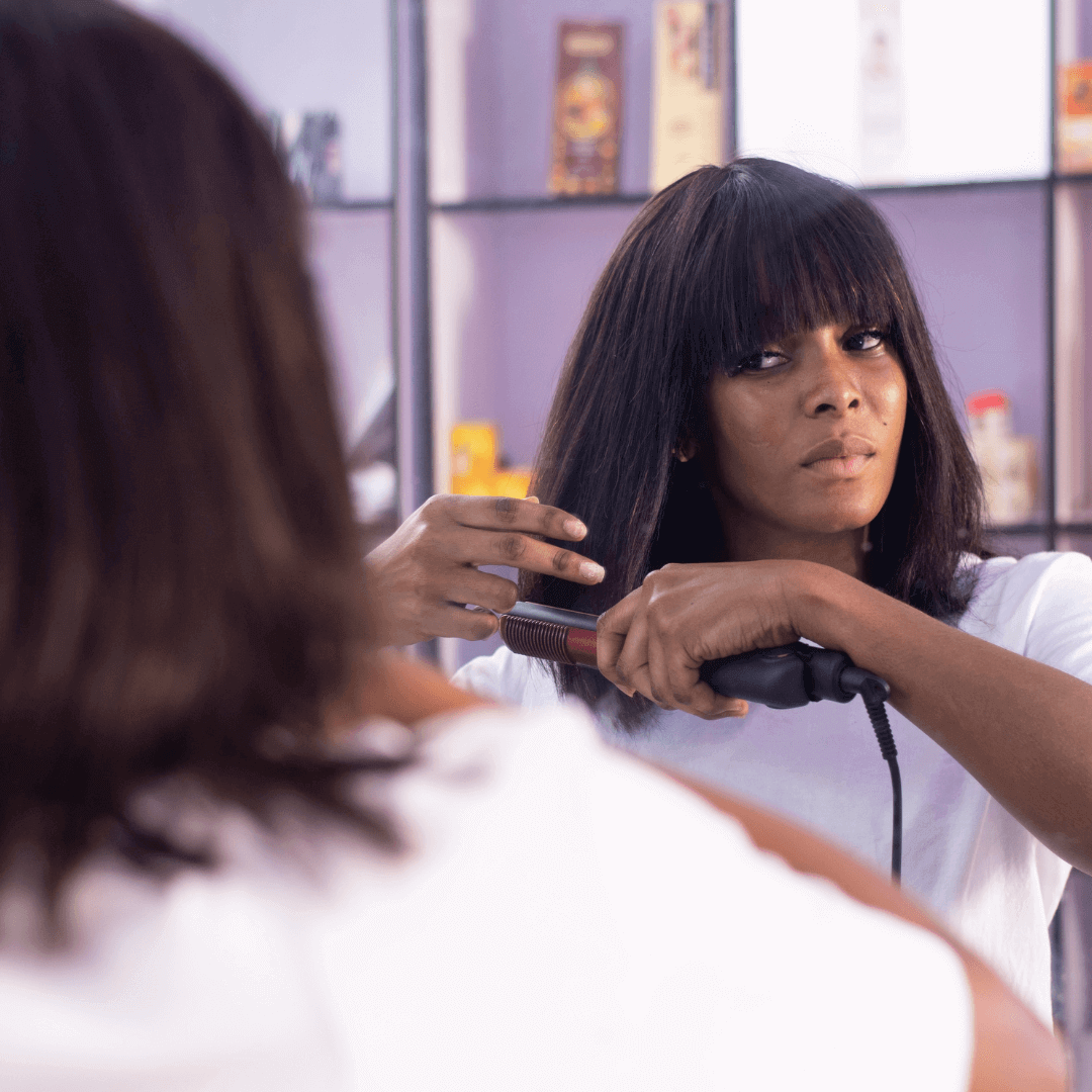 woman straightening hair