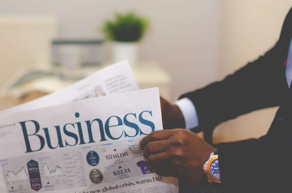 man holding business newspaper